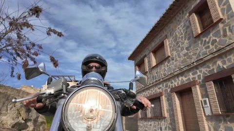 Closeup front view of a custom bike rider wearing a leather jacket and a Stock Footage 262543815