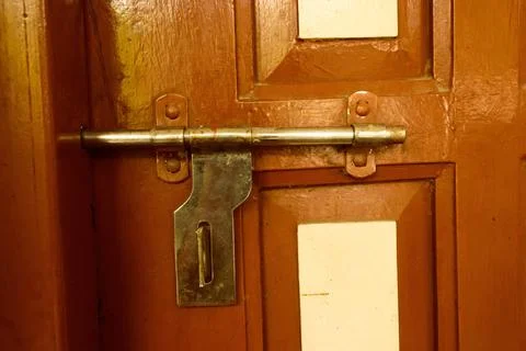  Closeup front view exterior rusty rough old brown wooden door handle of i... Stock Photos