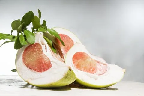 Closeup front view, sliced ​​red pomelo fruit, on a table Stock Photos
