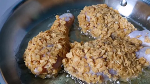 Closeup of Frying Breaded Chicken Legs Stock Footage 161006116