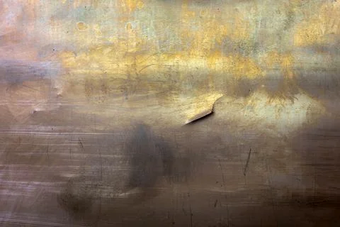 Closeup full-frame background and texture of yellow brass sheet with dent and Stock Photos