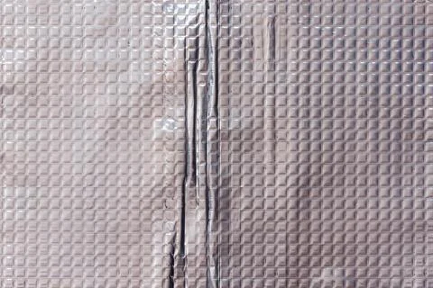 Closeup full-frame background and texture of aluminum coated butil rubber sheet Stock Photos