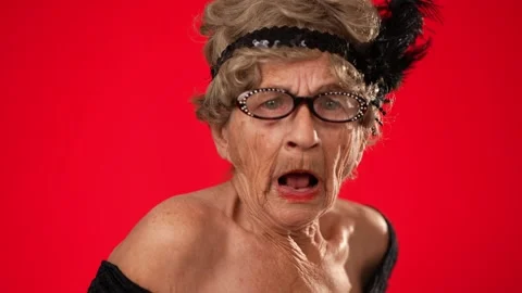 Closeup fun portrait of smiling elderly woman 80s years old walks into frame Stock Footage 258466956