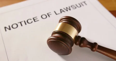 Closeup Of Gavel Over Notice Of Lawsuit Text 4K Stock Footage