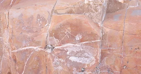 Closeup gimbal pull back of light multi color pink rock with layers of minerals  Stock Footage 316409167