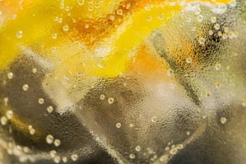 Closeup of gin glass with a lemon strip. Stock Photos