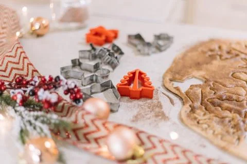Closeup of gingerbread cutting forms bordered by festive decorations. Stock Photos