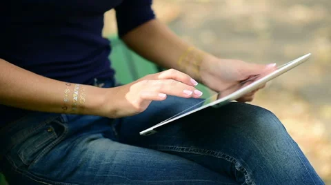 Closeup of a girl using tablet in the park 스톡 동영상 61004276