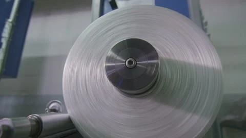Closeup glass thread rotating bobbin in workshop Stock Footage 89801275