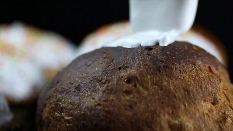 Closeup of glazing the icing with silicon brush onto Easter cake Video stock 74726739