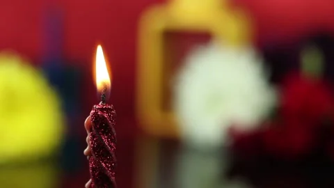 Closeup Of Glittering Red Designer Pillar Candle Illuminated Stock Footage 165417213