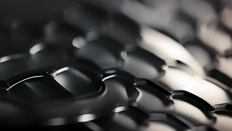 Closeup of a glossy plastic texture, with a raised honeycomb pattern that adds Stock Footage 253927672