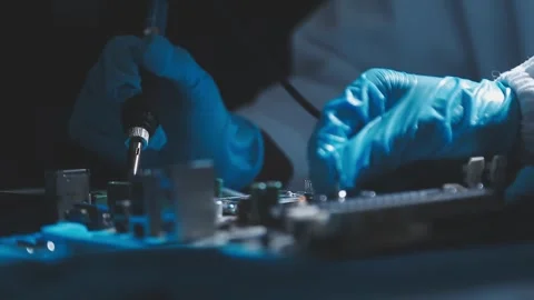 Closeup of a gloved hand installing a microchip on a blue motherboard. Perf.. Stock Footage 341547228