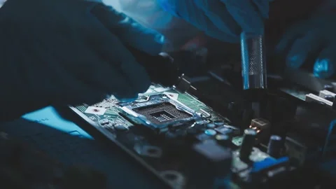 Closeup of a gloved hand installing a microchip on a blue motherboard. Perf.. Stock Footage 341547250