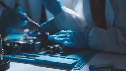 Closeup of a gloved hand installing a microchip on a blue motherboard. Perf.. Stock Footage 341547278
