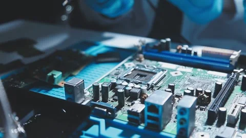 Closeup of a gloved hand installing a microchip on a blue motherboard. Perf.. Stock Footage 341547293