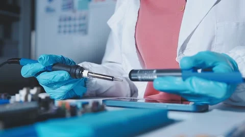 Closeup of a gloved hand installing a microchip on a blue motherboard. Perf.. Stock Footage 341547314