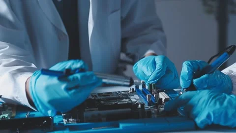 Closeup of a gloved hand installing a microchip on a blue motherboard. Perf.. Stock Footage 341547353