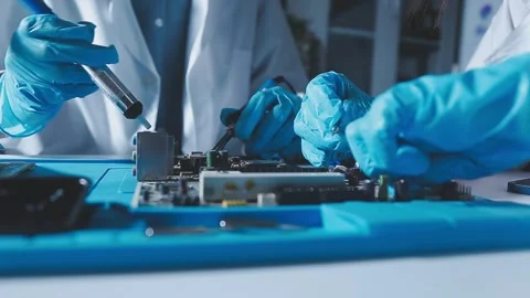 Closeup of a gloved hand installing a microchip on a blue motherboard. Perf.. Stock Footage 341547381