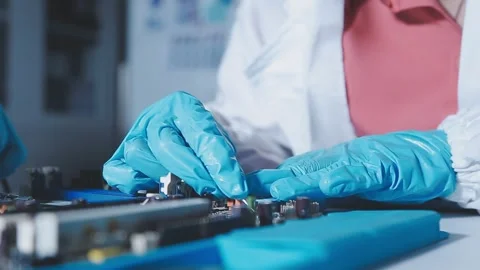Closeup of a gloved hand installing a microchip on a blue motherboard. Perf.. Stock Footage 341547384
