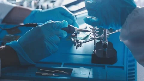 Closeup of a gloved hand installing a microchip on a blue motherboard. Perf.. Stock Footage 341547398