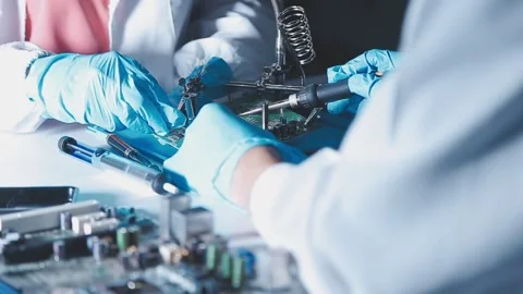 Closeup of a gloved hand installing a microchip on a blue motherboard. Perf.. Stock Footage 341547417