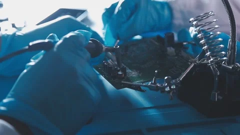 Closeup of a gloved hand installing a microchip on a blue motherboard. Perf.. Stock Footage 341547425