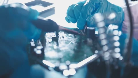 Closeup of a gloved hand installing a microchip on a blue motherboard. Perf.. Stock Footage 341547429