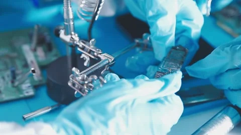 Closeup of a gloved hand installing a microchip on a blue motherboard. Perf.. Stock Footage 341547492
