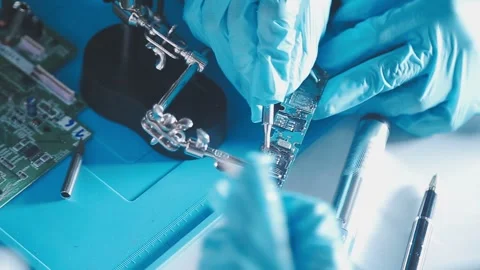 Closeup of a gloved hand installing a microchip on a blue motherboard. Perf.. Stock Footage 341547493