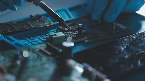 Closeup of a gloved hand installing a microchip on a blue motherboard. Perf.. Stock Footage 341547521