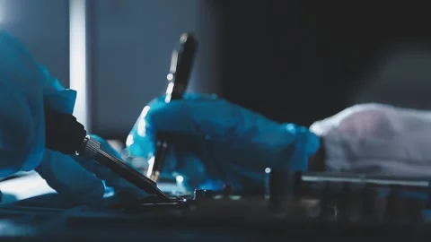 Closeup of a gloved hand installing a microchip on a blue motherboard. Perf.. Stock Footage 341547558
