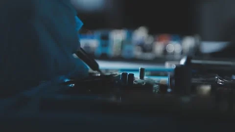 Closeup of a gloved hand installing a microchip on a blue motherboard. Perf.. Stock Footage 341547568