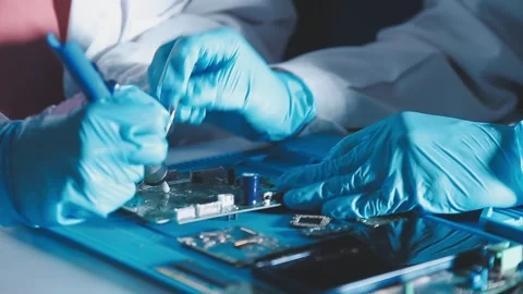 Closeup of a gloved hand installing a microchip on a blue motherboard. Perf.. Stock Footage 341547604