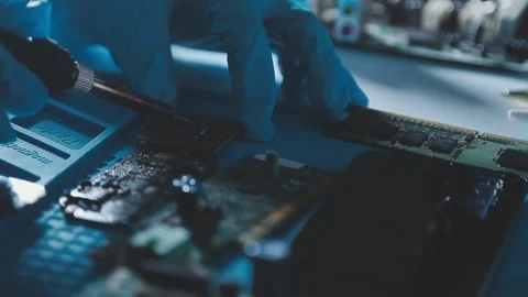 Closeup of a gloved hand installing a microchip on a blue motherboard. Perf.. Stock Footage 341550074