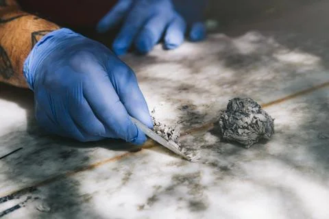 Closeup of gloved hands removing old wax with a wax comb. Stock Photos