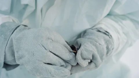 Closeup of gloves lighting tiny sparks. Field worker carefully strikes match Video stock 342741416