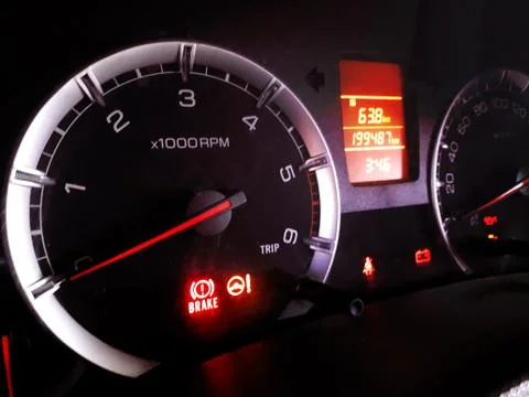 Closeup of glowing digital dashboard of a car at night indicating speed, fuel Stock Photos