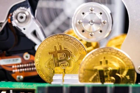 Closeup of gold bitcoin on computer components background, technology and dig Stock Photos