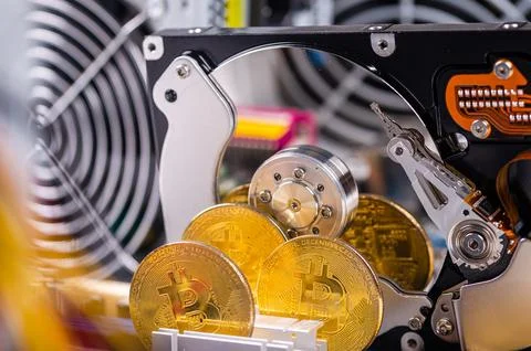 Closeup of gold bitcoin on computer components background, technology and dig Stock Photos