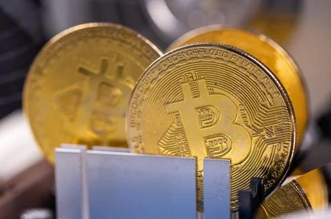 Closeup of gold bitcoin on computer components background, technology and d.. Stock Photos