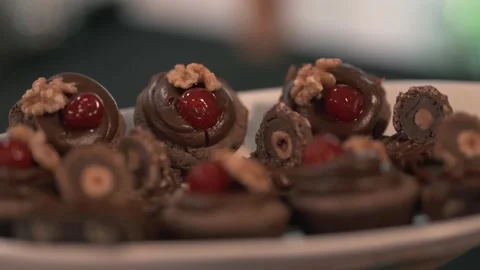 Closeup of gourmet chocolates with cherry and walnut toppings on a wedding Stock Footage 325359529