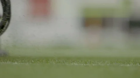 Closeup of grass mowing machine trimming grass on football field Stock Footage 104769133