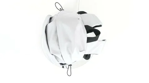 Closeup gray backpack bag rotates on white background, top view, 4K Stock Footage 231625132