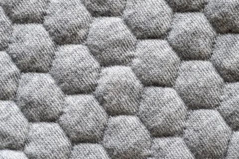 Closeup of gray fabric texture with hexagonal pattern for background Stock Photos