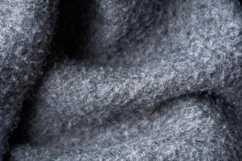 Closeup gray texture of woolen knitted fabric. Pattern of gray crumpled fabri Stock Photos