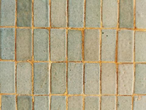 Closeup of a gray wall of rectangular tiles as a background Stock Photos