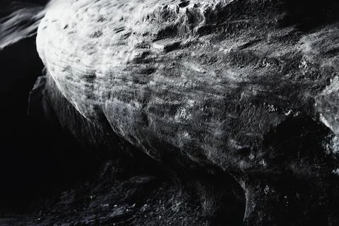 Closeup grayscale shot of rock with a bumpy surface Stock Photos