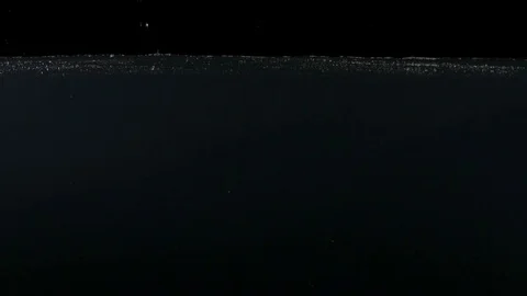 Closeup of green apple falling into water on the black backgrond slow motion Stock Footage 75789533