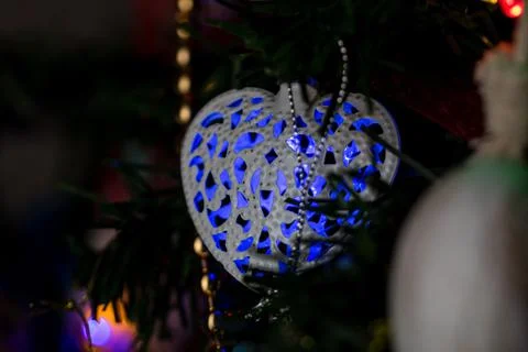 Closeup of a green heart-shaped string light on a Christmas tree Foto stock